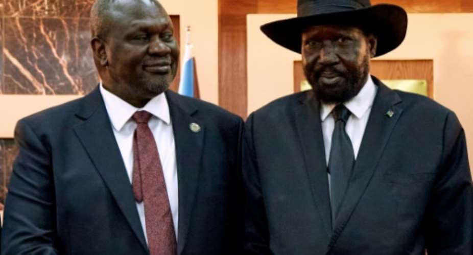 South Sudanese President Salva Kiir R shakes hands with First Vice President Riek Machar in 2020.  By ALEX MCBRIDE AFP