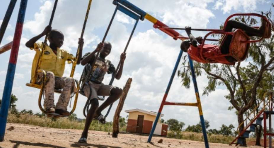South Sudanese refugee children play on a swing set at the Bidibidi refugee settlement in the Northern District of Yumbe, Uganda in 2017.  By Isaac Kasamani AFPFile