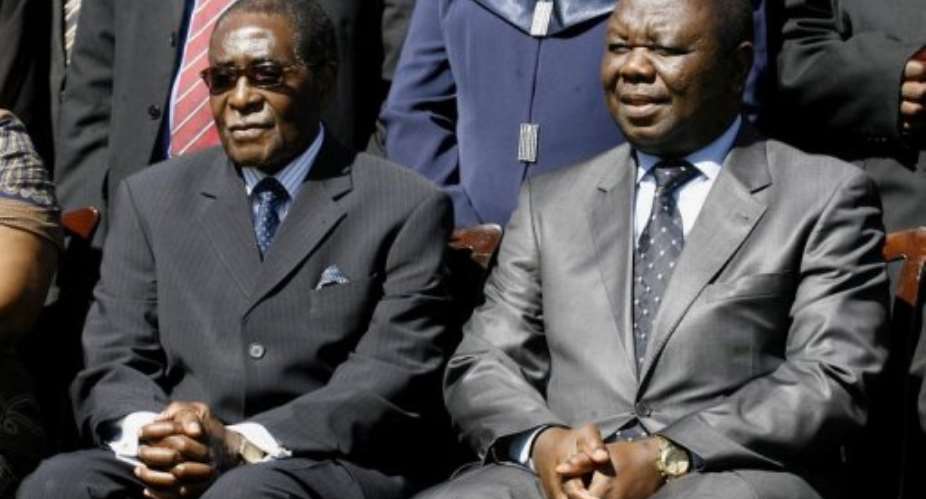 Tsvangirai right and Mugabe formed a coalition government in February 2009.  By Desmond Kwande AFP