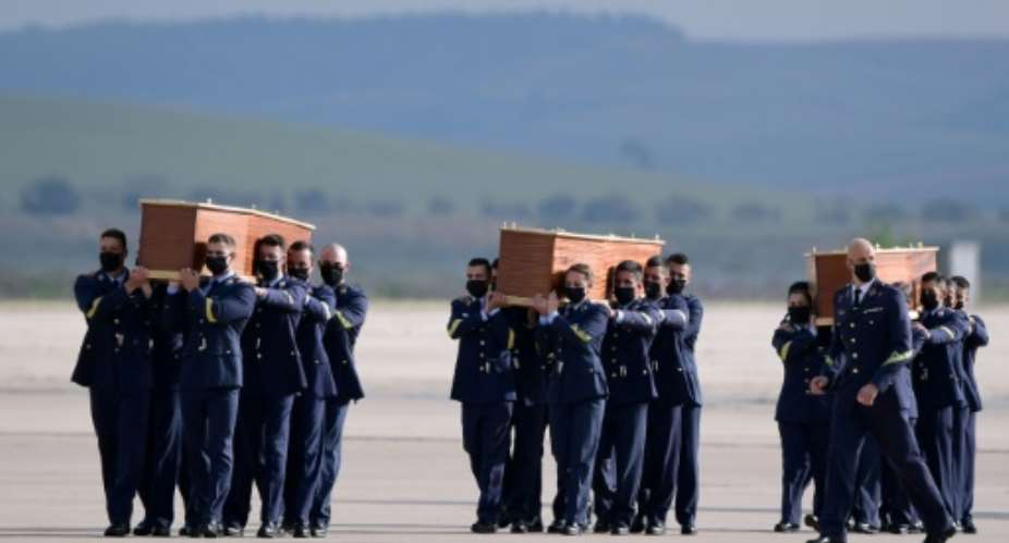 Spanish air force officers carried the coffins containing the bodies of  the three Europeans killed.  By JAVIER SORIANO AFP