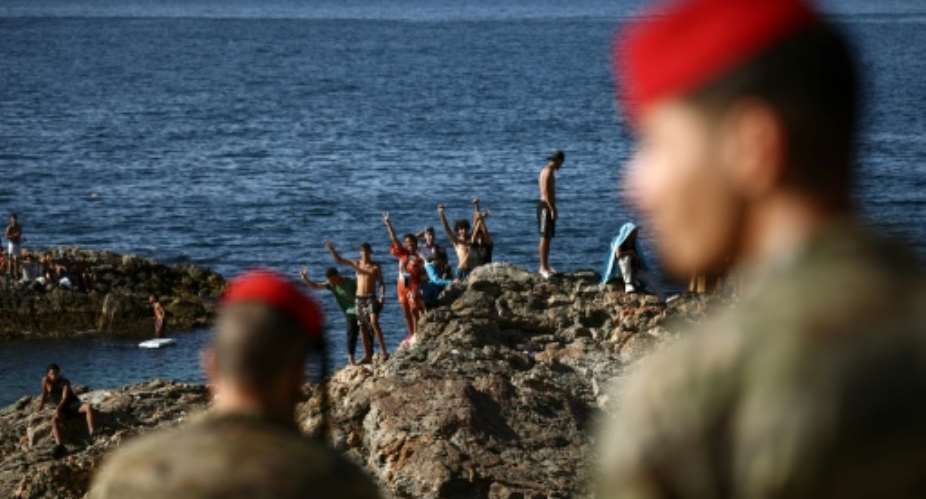 Spanish police and troops patrol the streets of Ceuta.  By Henry NICHOLLS (AFP)
