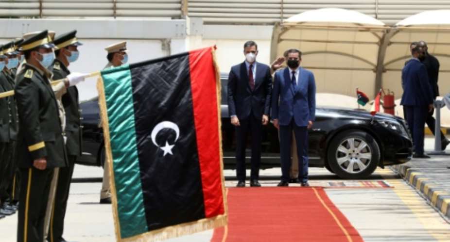Spanish Prime Minister Pedro Sanchez L is welcomed by his Libyan counterpart Abdulhamid Dbeibah in Tripoli on June 3, 2021.  By Mahmud Turkia AFP