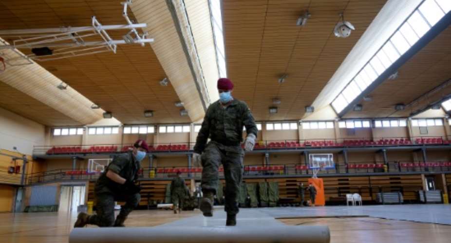 Spanish soldiers are setting up temporary shelters for homeless people in a country where more than 10,000 people have now died.  By JOSE JORDAN STRAFP