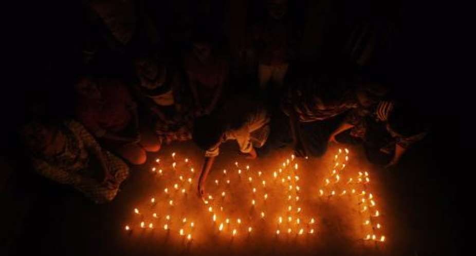 Indian school children light candles forming the date '2014' at a school in Agartala on December 30, 2013, one day ahead of New Year's celebrations.  By Arindam Dey AFP