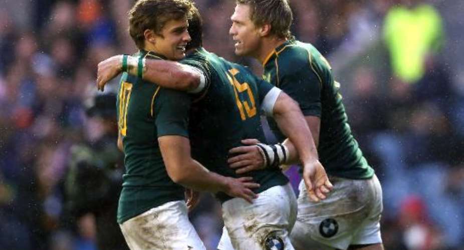 South Africa's Willie le Roux C celebrates after scoring a try with Jean De Villiers R and Patrick Lambieat Murrayfield Stadium in Edinburgh, Scotland, on November 17, 2013.  By Ian MacNicol, Ian MacNicol AFP