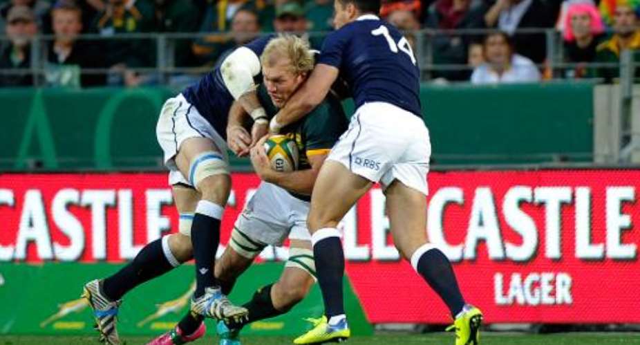 South Africa's flanker Schalk Burger C is tackled during an International Rugby test match against Scotland on June 28, 2014 in Port Elizabeth, South Africa.  By Gianluigi Guercia AFPFile