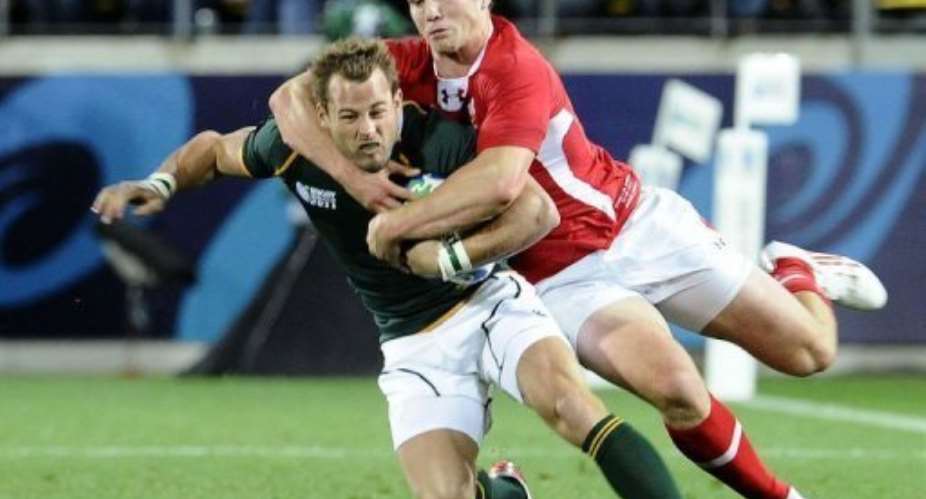 South Africas Francois Hougaard (L) is tackled by Wales wing George North.  By Stephane de Sakutin (AFP)