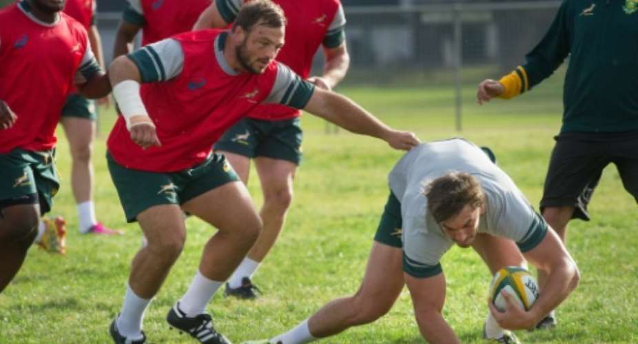 South Africa tighthead prop Julian Redelinghuys C,L tackles Eben Etsebeth R during a Springbok training session in Stellenbosch, near Cape Town on 30 May, 2016.  By Rodger Bosch AFPFile