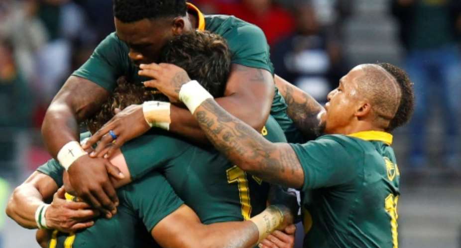 Springboks winger Courtnall Skosan L11 is mobbed by teammates as he celebrates scoring a try during the International Rugby Test match against Argentina August 19, 2017.  By MICHAEL SHEEHAN AFP