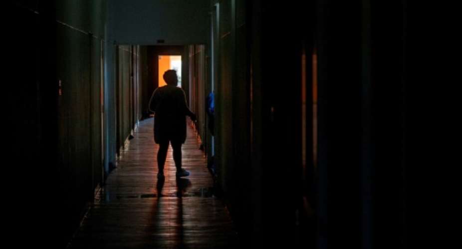 Squatters in a rundown building in central Cape Town have no access to either electricity or water.  By RODGER BOSCH AFP