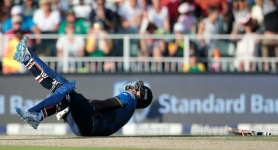 Sri Lanka batsman and captain Angelo Mathews falls on the ground after twisting his ankle during their second Twenty20 match against South Africa, at Wanderers cricket ground in Johannesburg, on January 22, 2017.  By GIANLUIGI GUERCIA AFP