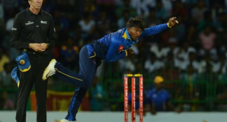 Sri Lanka's Akila Dananjaya delivers the ball on August 12, 2018.  By LAKRUWAN WANNIARACHCHI AFP