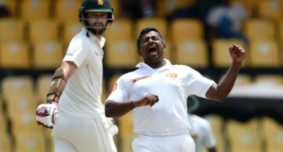 Sri Lanka's Rangana Herath R celebrates after dismissing Zimbabwe's Hamilton Masakadza.  By ISHARA S. KODIKARA AFP