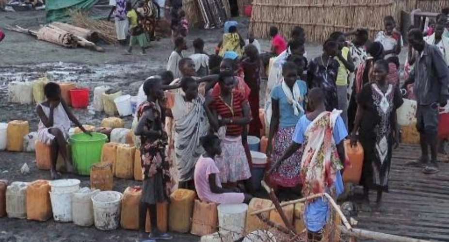 A grab from an UNMISS video shows displaced people gathering water at a camp in Bentiu on April 22, 2014.  By  United Nations Mission in South SudanAFP