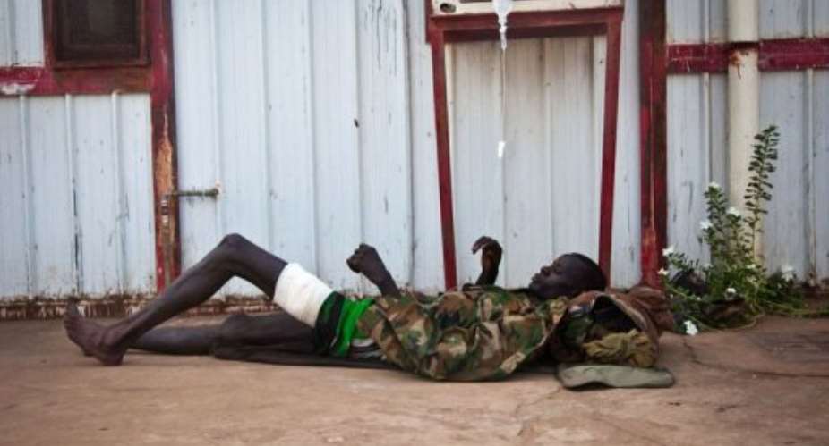 A wounded soldier of the South-Sudan's Sudan People's Liberation Army SPLA rests outside the Rubkona Military Hospital.  By Adriane Ohanesian AFP
