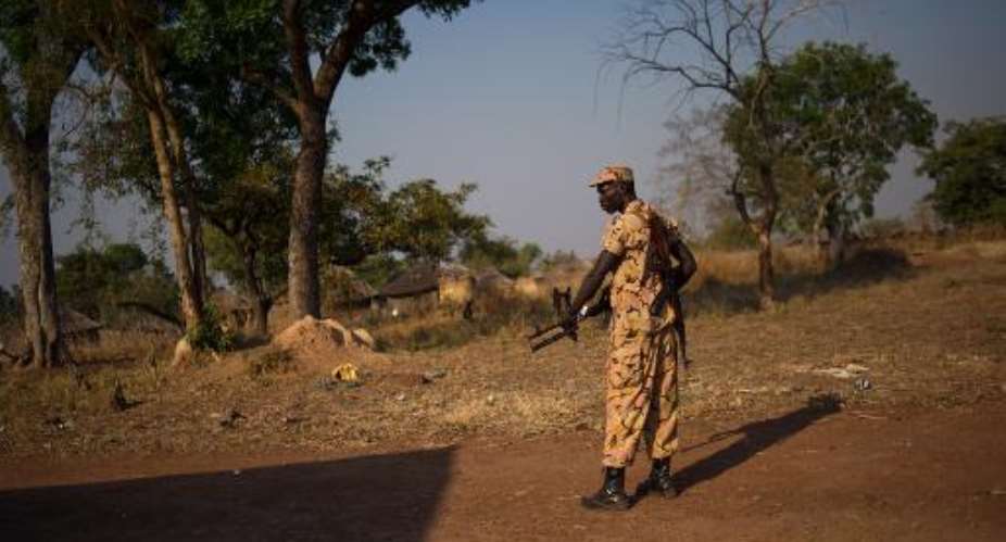 A South Sudanese policeman stands guard in Mvolo, in the Western Equatoria state, on January 14, 2014.  By Phil Moore AFPFile