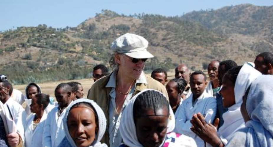 A picture taken on November 25, 2009, shows founder of the Band Aid charity Bob Geldof C with local people during a visit to Korem in Ethiopia.  By Aaron Maasho AFPFile