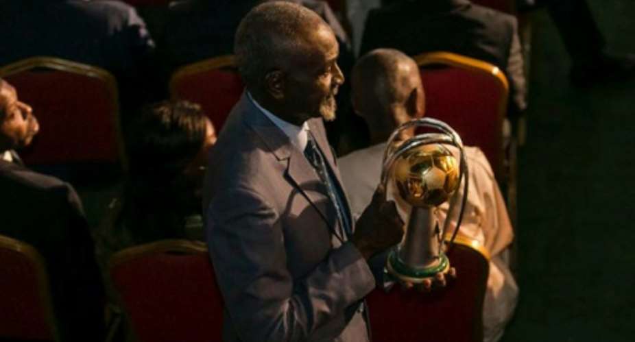 Stephen Tataw carries the trophy of the African Championship of Nations CHAN to the stage during the draw ceremony in Yaounde in February.  By STRINGER AFPFile