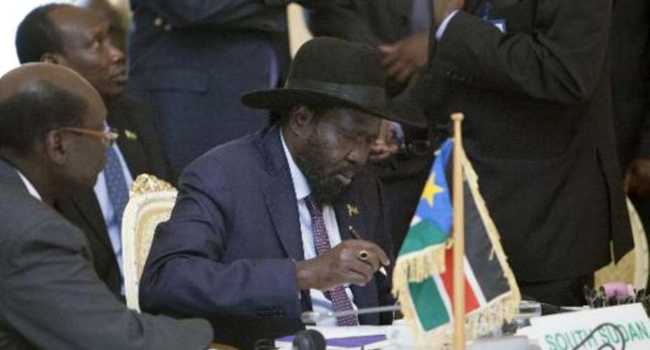 South Sudanese President Salva Kiir signs the statement of principles for the negotiations of the national unity government of South Sudan at the National Palace in Addis Ababa on August 25, 2014.  By Zacharias Abubeker AFPFile