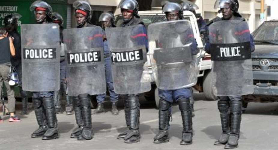 Riot police stand guard in Independant Sqaure in Dakar on February 22, 2012.  By Seyllou AFPFile