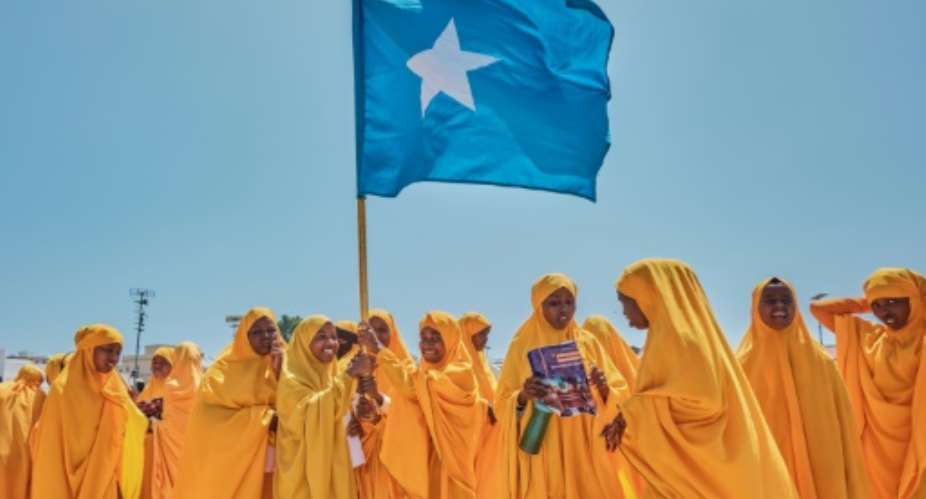 Students wave a Somali flag during a demonstration in support of the government over the controversial deal between Ethiopia and the breakaway region of Somaliland.  By ABDISHUKRI HAYBE (AFP)