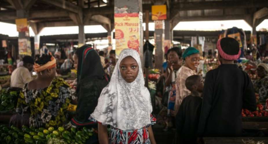A Muslim woman is seen shopping in the popular district of Poto Poto market on July 22, 2015, in Brazzaville.  By Federico Scoppa AFPFile