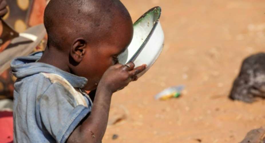 An internally displaced child drinks water at Zam Zam camp for Internally Displaced People near El Fasher in Darfur on February 18, 2015.  By Hamid Abdulsalam United Nations-African Union Mission in DarfurAFPFile