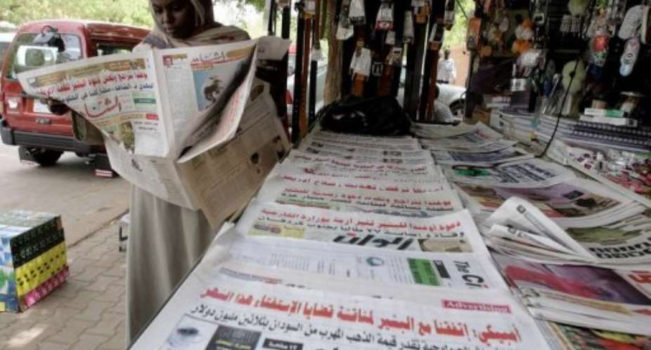 A Sudanese woman reads a newspaper in Khartoum.  By Ashraf Shazly AFPFile