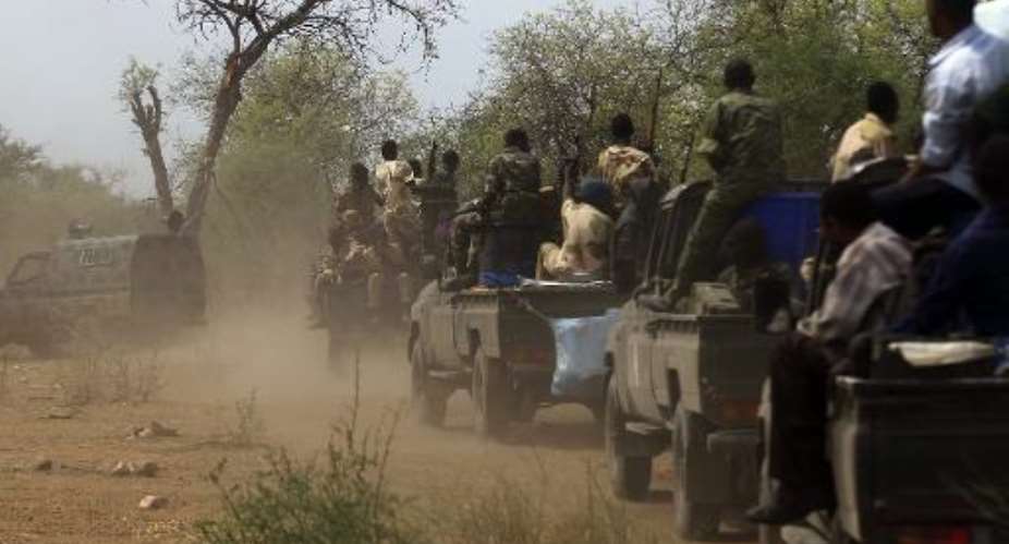 This photo taken on May 20, 2014 shows Sudanese soldiers patrol the Daldako area, about 12 miles northeast of the capital, where the rebels shelled in a counter attack Saturday.  By  AFPFile