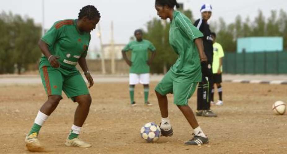 Sara Edward L, the coach of Sudanese female football team The Challenge takes part in a training session at a picth near Khartoum's aiport.  By Ashraf Shazly AFP