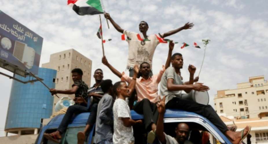 Sudanese celebrate a hard-won deal between protest leaders and the country's ruling generals aimed at turning the page on months of political unrest.  By ASHRAF SHAZLY AFP