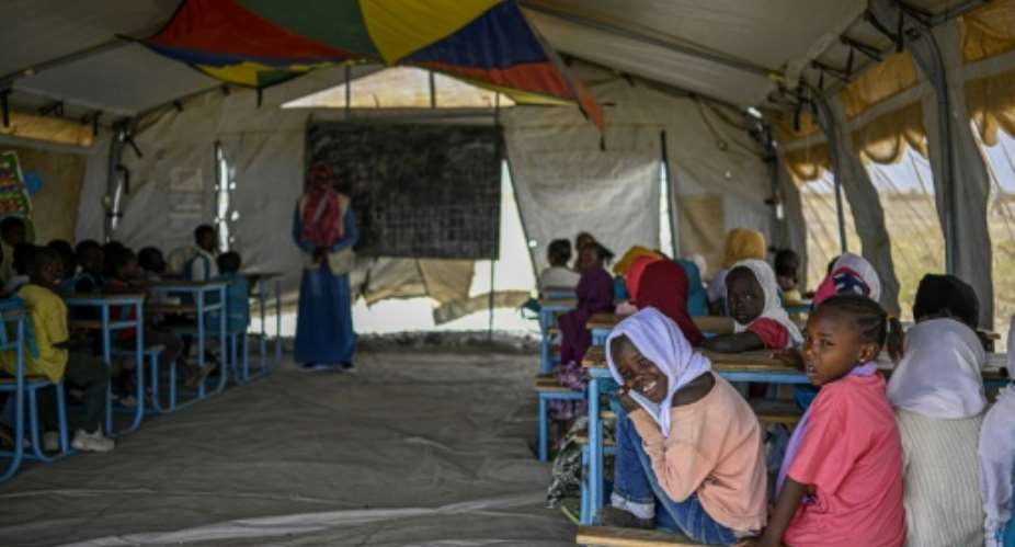 Sudanese children attend class in a tent at a displacement camp.  By Khaled DESOUKI (AFP)