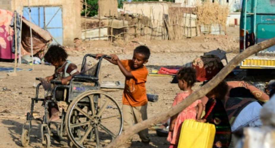 Sudanese children play on a street in Tokar, in Red Sea State, following heavy flooding in October, 2024.  By - (AFP/File)