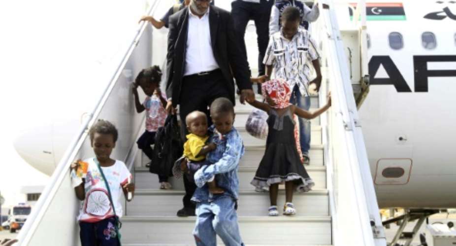 Sudanese children whose parents were reportedly jihadists in Libya get off a plane in Khartoum on June 20, 2017.  By Ebrahim Hamid AFP