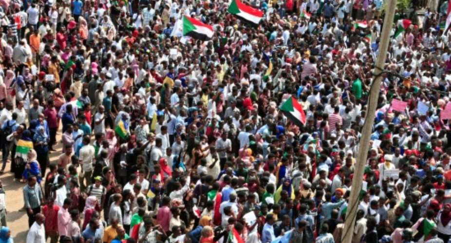 Sudanese citizens protested outside the presidential palace in Khartoum Thursday, in a bid to keep up the pressure on a transitional authority to ensure those responsible for killing demonstrators earlier this year are held to account.  By Ebrahim HAMID AFP