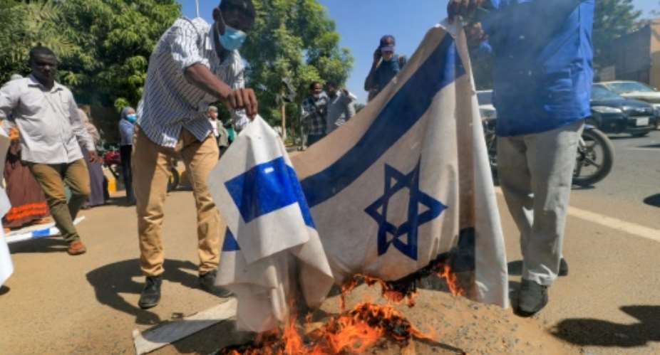Sudanese demonstrators burned an Israeli flag during a rally against their country's recent signing of a deal on normalising relations with the Jewish state.  By ASHRAF SHAZLY AFP