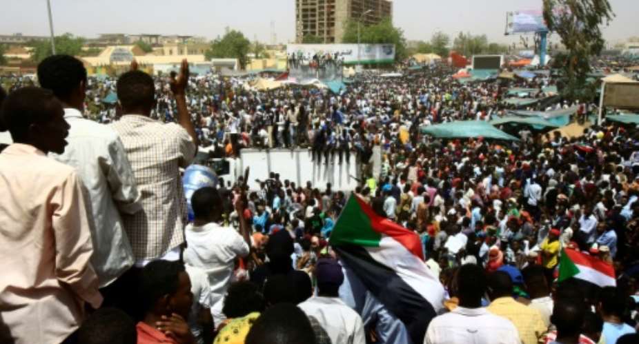 Sudanese demonstrators gather in Khartoum as the army says it has toppled Omar al-Bashir, one of Africa's longest-serving presidents.  By ASHRAF SHAZLY AFP