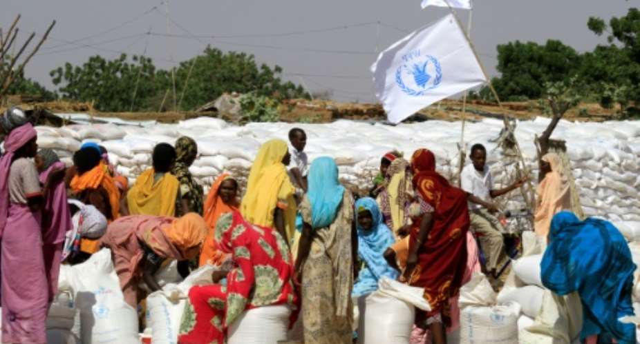 Sudanese displaced women collect humanitarian aid supplies provided by the UN's World Food Program in 2014 in the war-ravaged region of Darfur.  By Ashraf SHAZLY AFPFile
