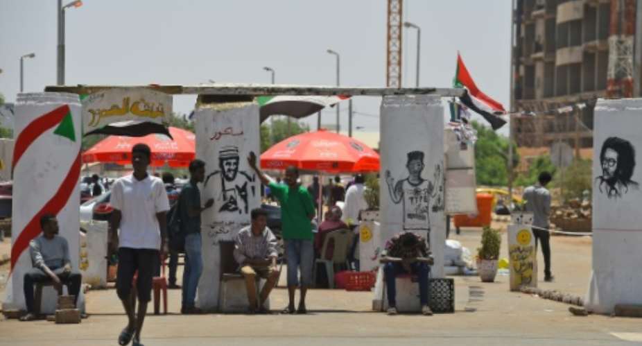 Sudanese graffiti artists commemorate five protesters shot dead at a longrunning sit-in outside army headquarters overnight in what protest leaders charged was a bid to derail talks with the country's military rulers.  By Mohamed el-Shahed AFP
