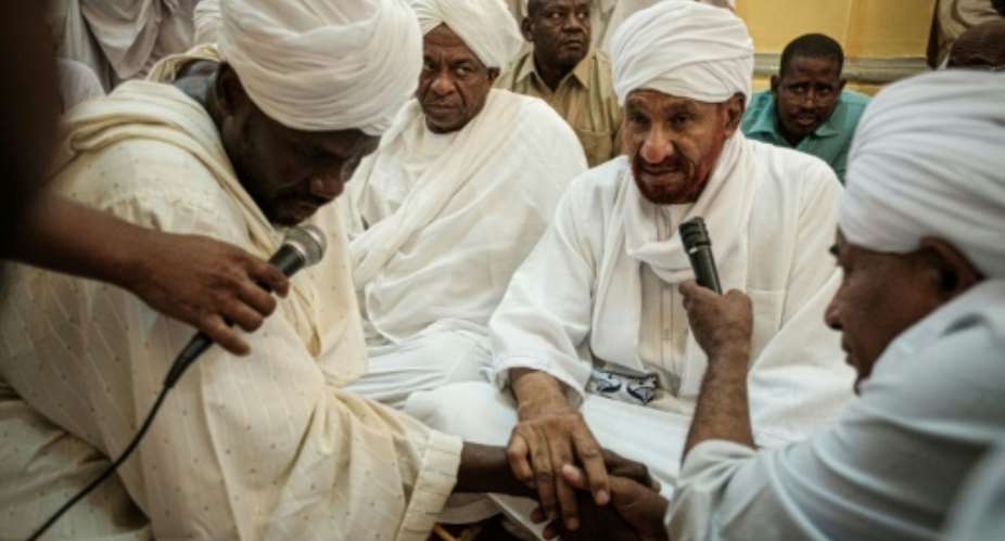 Sudanese opposition leader and former premier Sadiq al-Mahdi attends Friday prayers at a mosque linked to his National Umma Party in Khartoum's twin city of Omdurman on June 14, 2019.  By Yasuyoshi CHIBA AFP