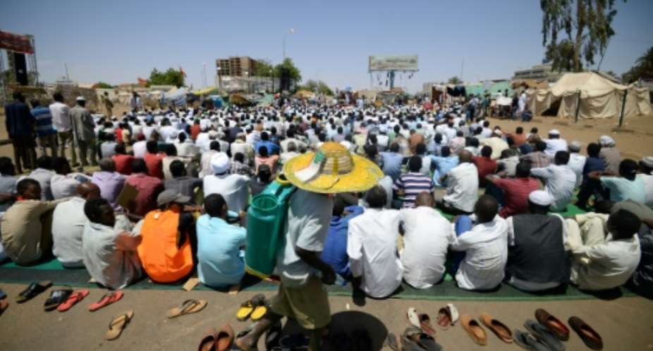 Sudanese protesters, attending Friday prayers near the military headquarters, have kept a sit-in at the site for weeks.  By MOHAMED EL-SHAHED AFP