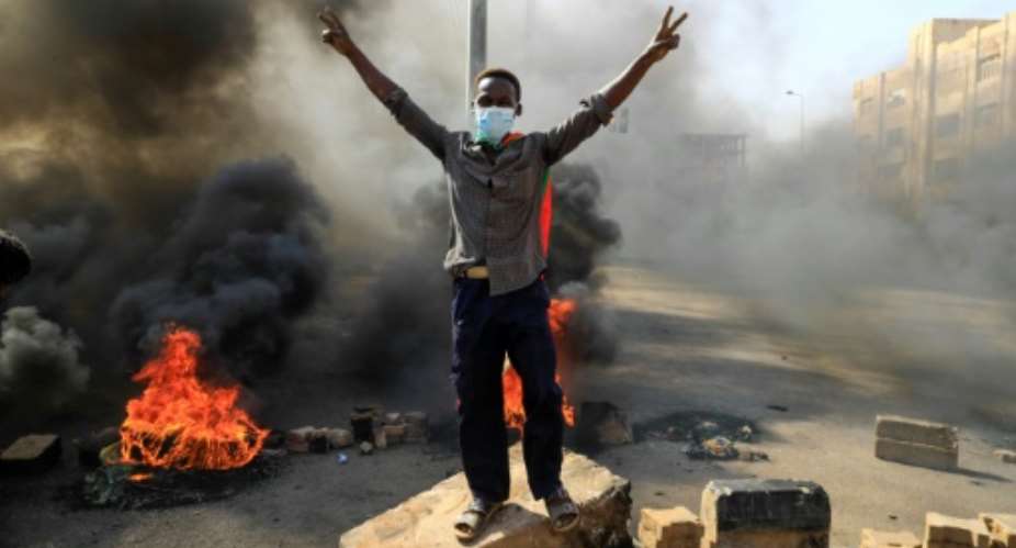 Sudanese protesters burn tyres to block a road in 60th Street in the capital Khartoum, to denounce overnight detentions by the army of members of Sudan's government, on October 25, 2021. Armed forces detained Sudan's Prime Minister over his refusal to support their coup, the information ministry said, after weeks of tensions between military and civilian figures who shared power since the ouster of autocrat Omar al-Bashir..  By - AFP