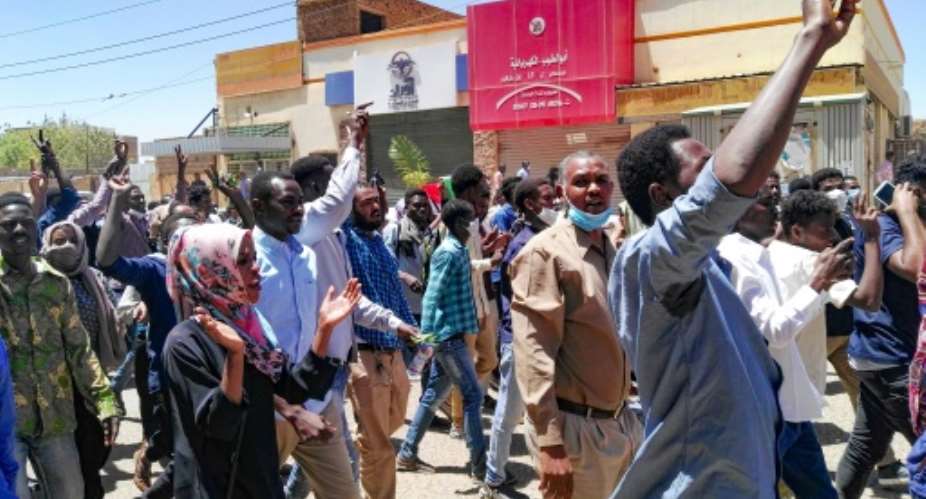 Sudanese protesters chant slogans as they respond to a call to march on the army headquarters in Khartoum.  By STRINGER AFP