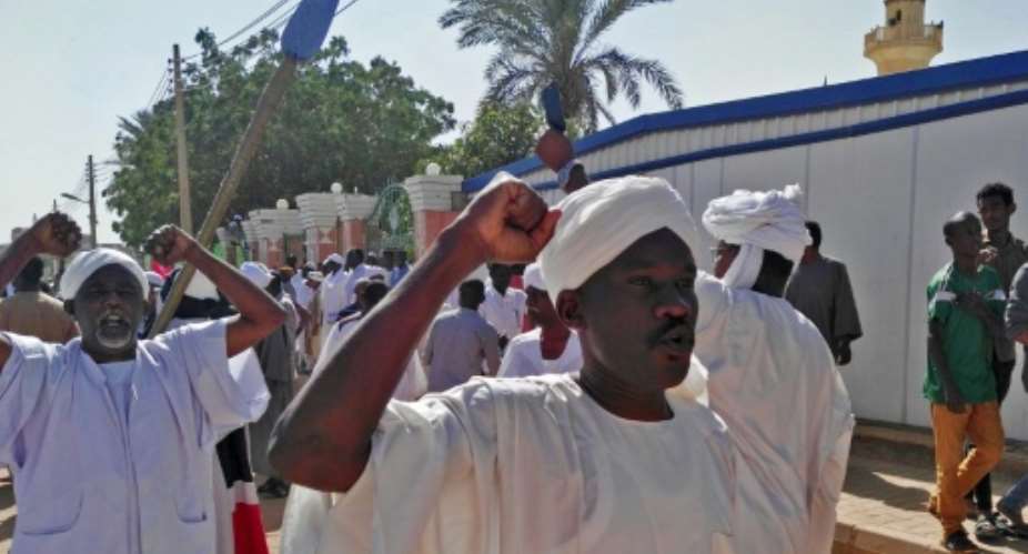 Sudanese protesters shout slogans against the government after prayers at a mosque in Khartoum's twin city Omdurman.  By - AFP