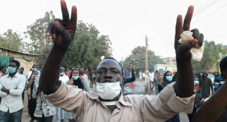 Sudanese protesters take part in an anti-government demonstration in Khartoum, as the government threatened legal action against the movement leaders.  By - AFP