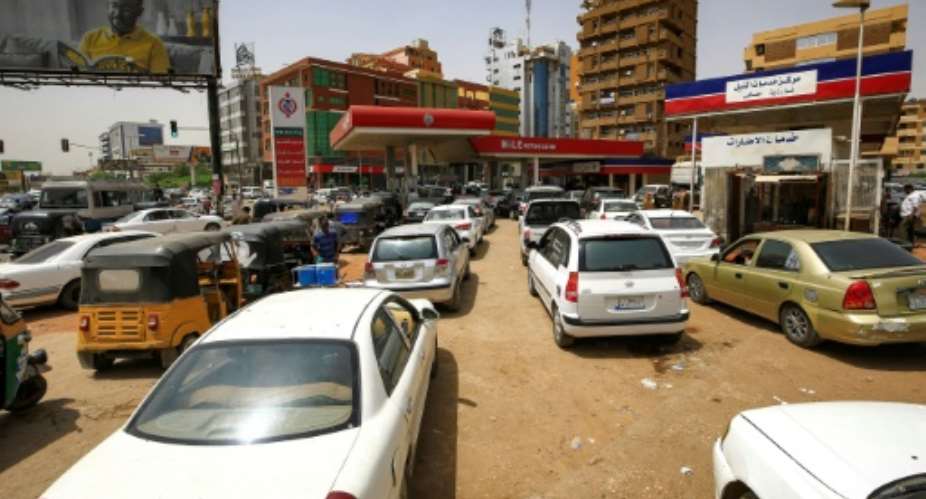 Sudanese queue up at petrol stations to fill up after the government decided to scrap subsidies on petrol and diesel, more that doubling prices.  By ASHRAF SHAZLY AFP