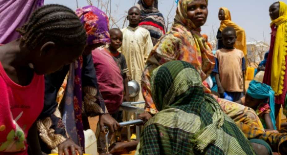 Sudanese refugees gather to fill cans with water in the Farchana refugee camp in Chad on April 8, 2024.  By Joris Bolomey (AFP/File)