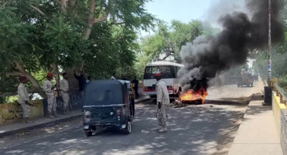 Sudanese security forces in Nyala, South Darfur state, intervene on October 17, 2021 after students set tyres on fire to protest hikes in bread prices due to the closure of Port Sudan which restricted wheat supplies.  By Abdelmonim MADIBU AFPFile