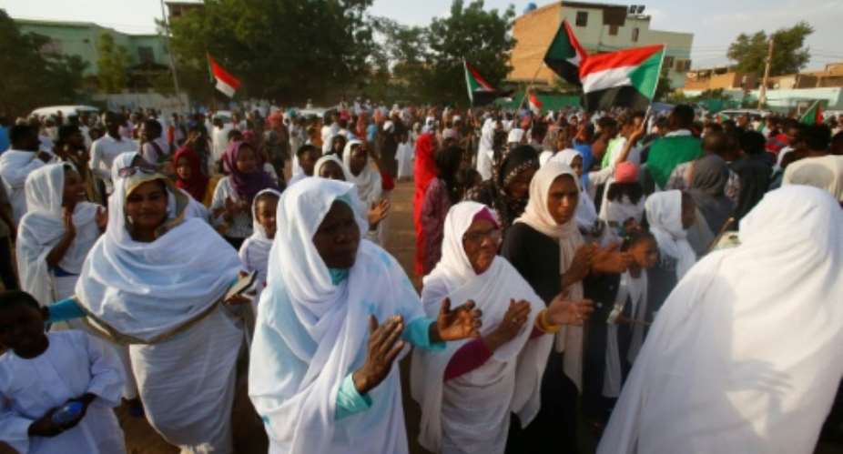 Sudanese women applauded on Saturday in celebration of a power sharing agreement between protest leaders and the ruling military council.  By ASHRAF SHAZLY AFP