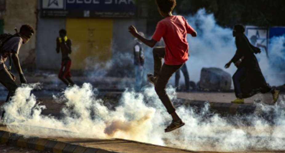 Sudanese youths take to the streets as security forces use tear gas to disperse protesters in the capital Khartoum, on Wednesday.  By - AFP